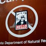 goatse obey sticker on a no camping sign.